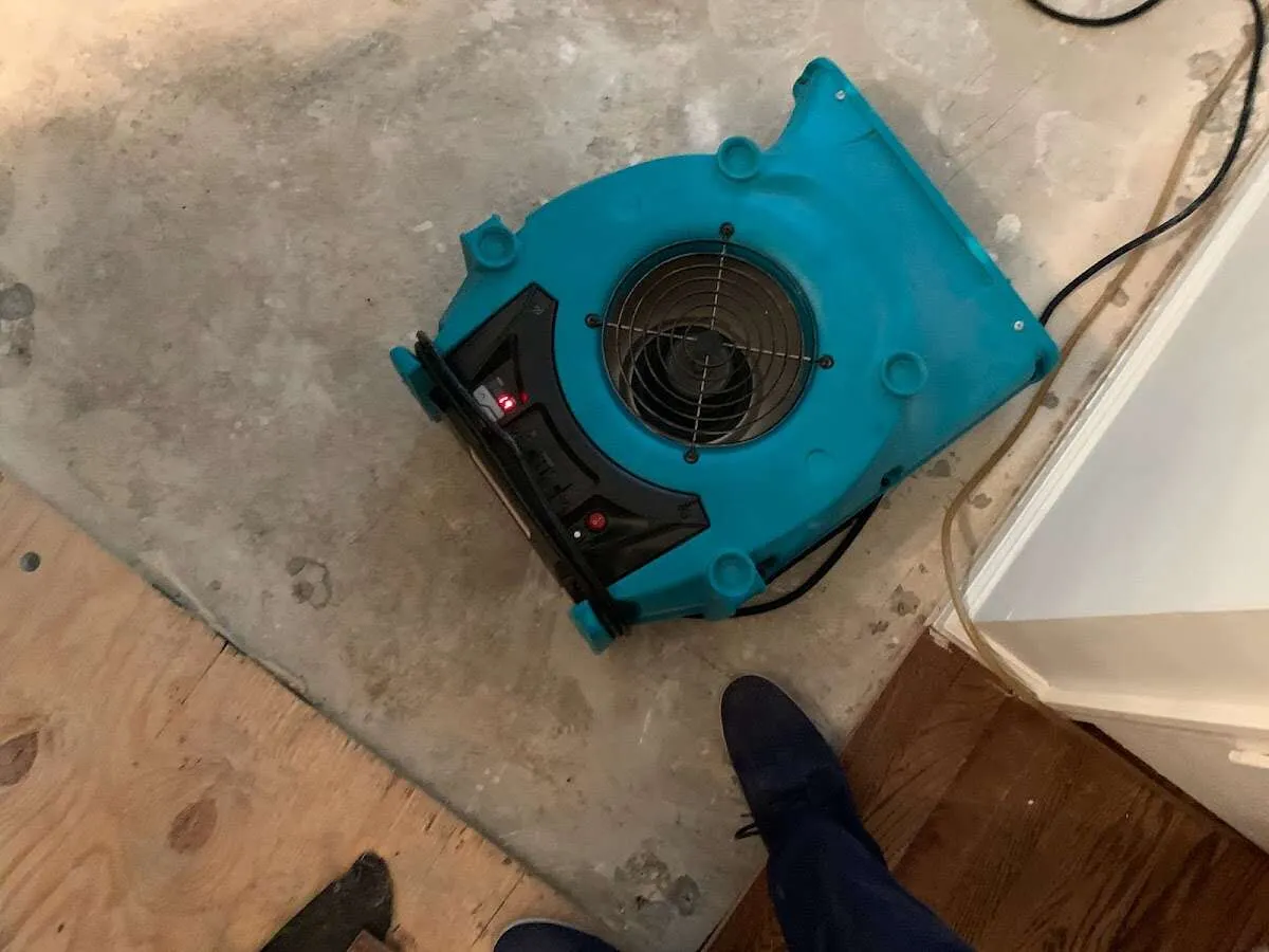 Air mover drying subfloor during Leak Detection & Repair in Wesley Hills